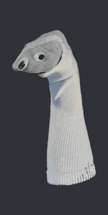 a white sock puppet with googly eyes and a red tongue sticking out