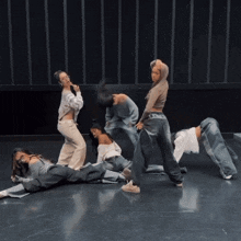 a group of women are dancing on a stage and one of them is wearing a hoodie that says ' a ' on it