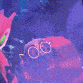 a red furry animal wearing goggles stands in front of a fish tank