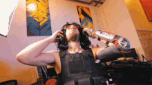 a man wearing sunglasses and a black vest with the letter n on his arm