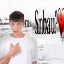 a young man is standing in front of a sign that says smbeau ?
