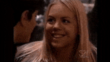 a man and a woman are smiling at each other .