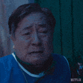 a man is wearing a blue vest with netflix written on it