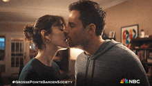 a man and a woman are kissing in a nbc ad