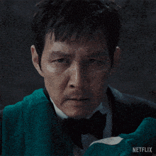 a man in a tuxedo with a netflix logo in the corner