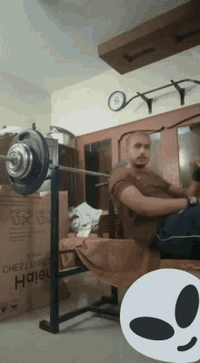 a man lifting a barbell in a room with a box that says ' height ' on it in the background