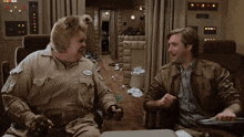 a man with a name tag that says burt sits with another man