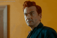 a man with red hair is standing in front of a yellow wall with the caption " itsscottiesstark " on the bottom