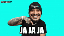 a man wearing a beanie and a black shirt with the words ja ja ja written on it