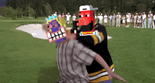 a group of people are standing on a golf course and one of them is wearing a mask that says ' i '