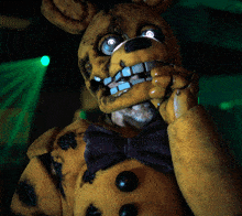a yellow stuffed animal with a bow tie and a beard