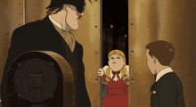 a man in a suit stands next to a girl in a red dress and two boys