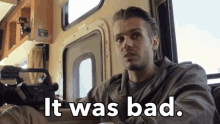 a man sitting in a rv with the words " it was bad " above him
