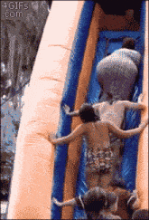 a group of people on a water slide with the website 4gifs.com visible in the corner