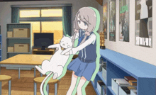 a girl holding a white cat in a room with posters on the wall including one that says ' love '