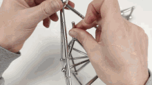 a person is holding a piece of metal in their hand