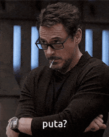 a man with glasses and a cigarette in his mouth is asking the question puta