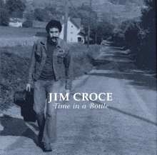 jim croce 's time in a bottle album cover shows a man walking down a road