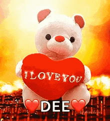 a white teddy bear is holding a red heart that says i love you dee