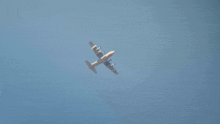 a plane flying through a clear blue sky