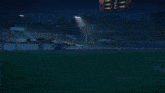 a car is driving down a road at night with the headlights on