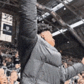 a man raising his arms in the air in front of a butler sign