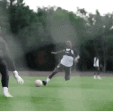 a blurry picture of a soccer player kicking a ball on a field