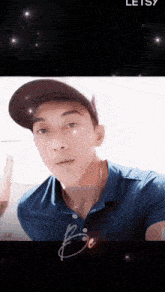 a young man wearing a baseball cap and a blue shirt with the word be on it