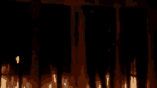 a silhouette of a person standing in front of a fire .