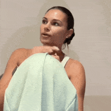 a woman with white nails is sitting on a bed with her feet up