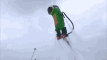 a man in a green suit is flying through the air on a jet pack .