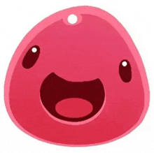 a pink slime with a smile on its face is sitting on a white surface .