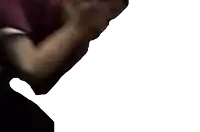 a person covering their face with their hands in a dark room