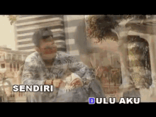 a video of a man with the words sendiri and dulu aku written on the bottom