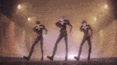 three anime characters are dancing together in a dark room