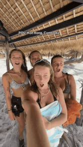 a group of women are posing for a picture with koh rong cambodia written above them