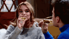 a man and a woman are toasting with champagne
