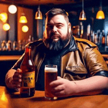 a man is sitting at a bar holding a bottle of beer and a glass of beer .
