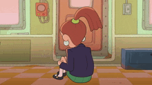 a girl in a ponytail sits on the floor in a room