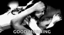 a black and white photo of a man and woman hugging each other with the words `` good morning '' .