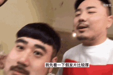 a man with a mustache is talking to another man