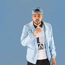a man wearing a light blue jacket and a white shirt that says lg1