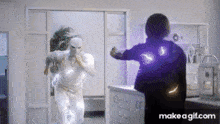 a gif of a man in a white suit fighting another man