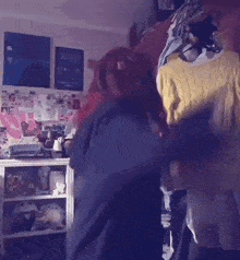a woman with red hair is standing in a room with a yellow shirt on