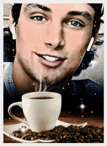 a man is smiling next to a cup of coffee and a plate of coffee beans