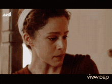 a close up of a woman 's face on a tv screen with vivavideo written on the bottom