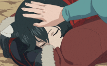 a person laying down with their hand on the head of another person