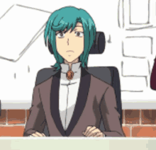 a man with green hair is sitting at a table in a suit
