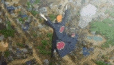 a person is flying through the air with their arms outstretched in front of a city .