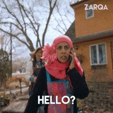 a woman with a flower in her hair is talking on a cell phone and the word hello is on her face
